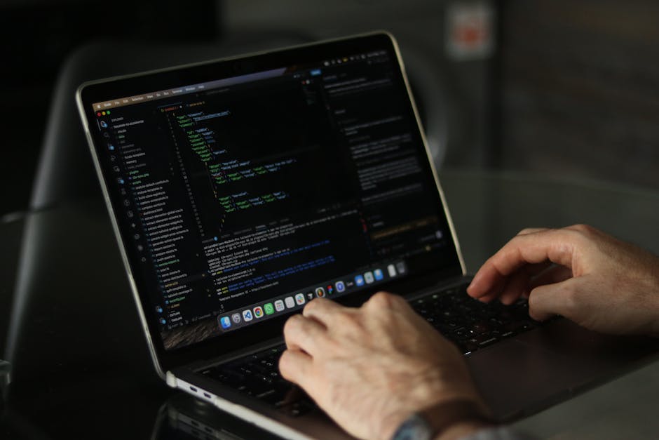 A close-up image of a computer screen displaying lines of colourful code, including various programming keywords, symbols, and syntax. The code is presented in multicoloured text on a dark background,